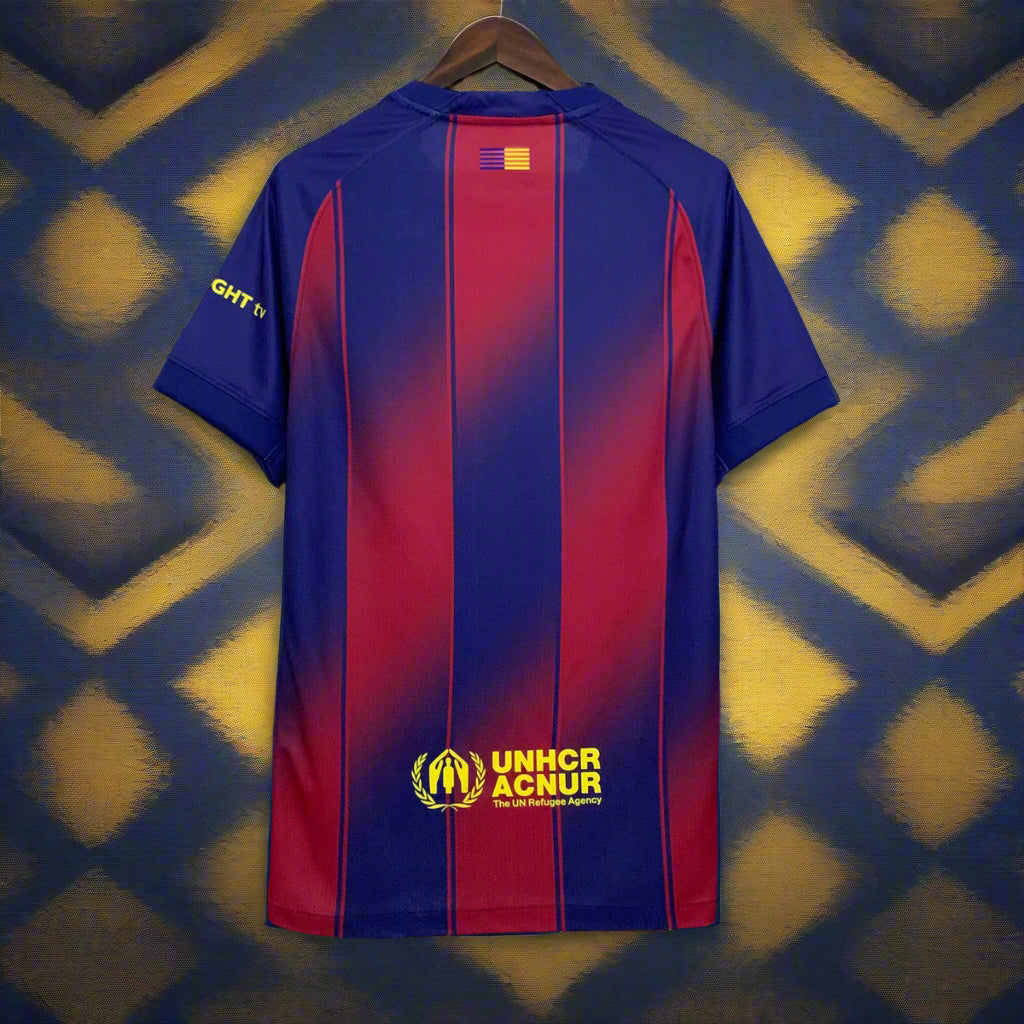 Blue and red sports jersey with UNHCR ACNUR logo on a hanger against a grid background